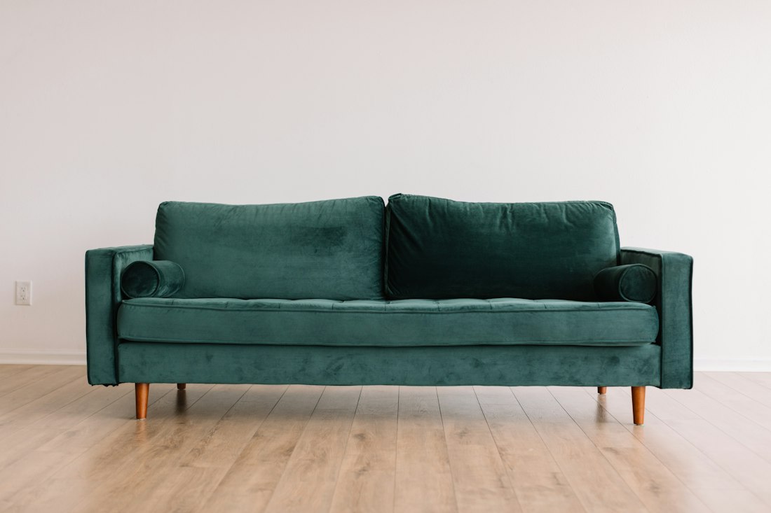 Modern sofa with framed wall art and warm wood accents