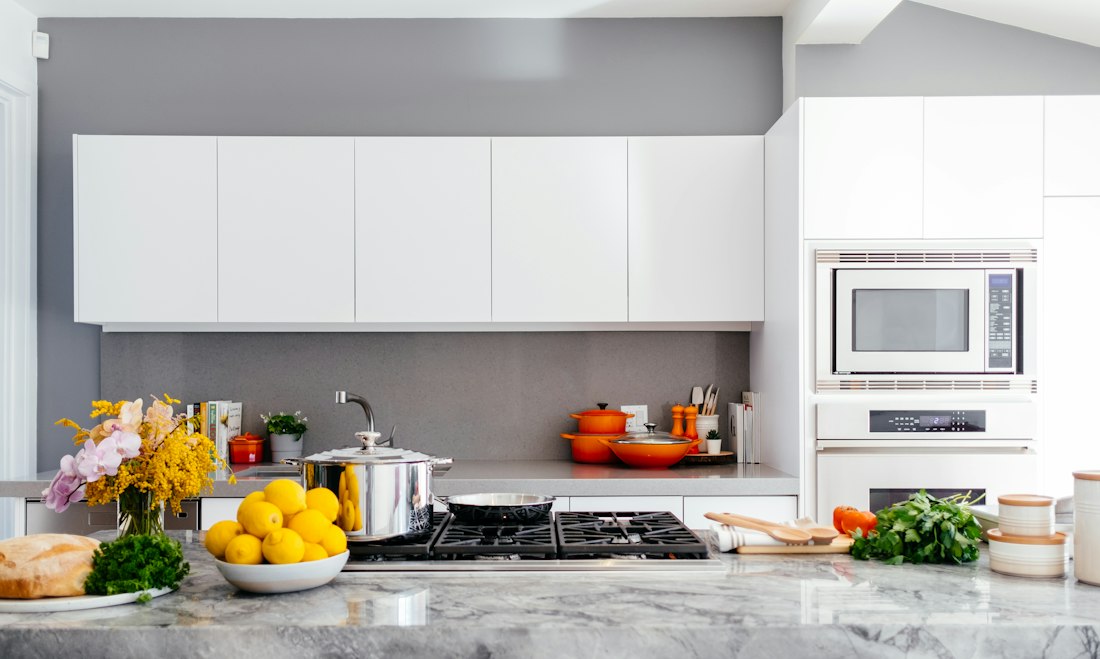 Warm modern kitchen and dining space with pendant lights