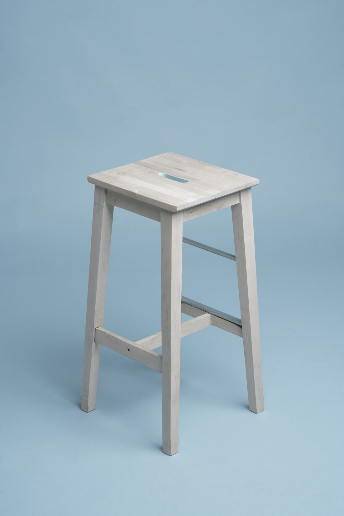 Warm natural wood stool and thoughtful home accents